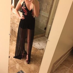 Black romper with maxi skirt and rosette details